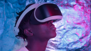 Individual wearing a VR headset, emblematic of technological advancements shaping the future trade show landscape, as virtual reality transforms traditional exhibition experiences.